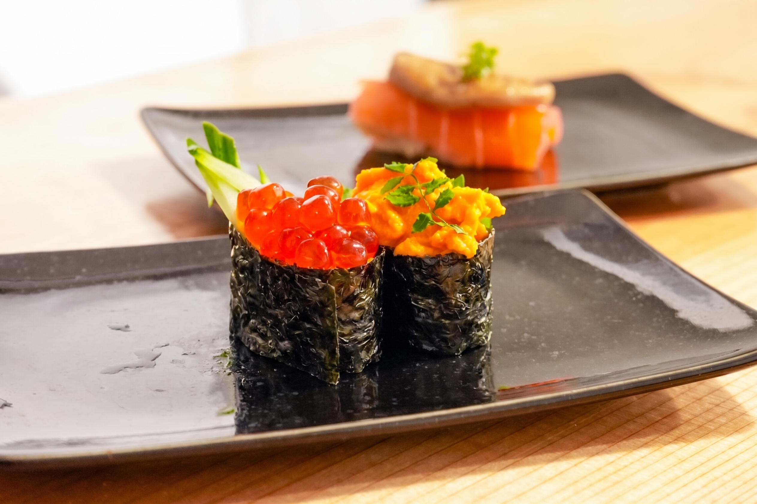 Gunkan-style nigiri topped with ikura and uni